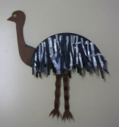 an ostrich is made out of strips of paper and duct taped to the wall