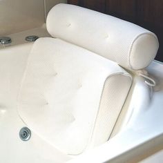 a white bath tub sitting next to a wooden wall