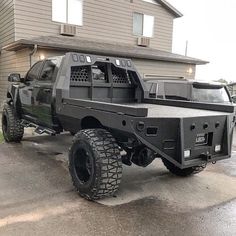 a black truck parked in front of a house