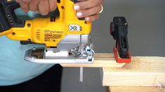 a person using a power tool on a piece of wood