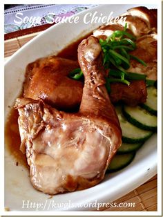 a white plate topped with meat and cucumbers