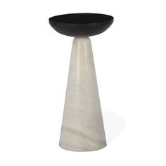 a black and white vase sitting on top of a table