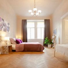 a bedroom with hardwood floors and white walls