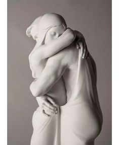 a sculpture of a woman hugging her body