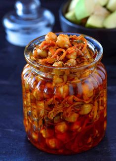 a glass jar filled with food sitting on top of a table