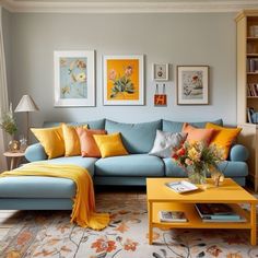 a living room with blue couches and yellow pillows on the floor, bookshelves in the background