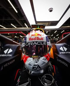 a red bull motorcycle helmet on display in a showroom