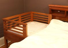 a bed with a wooden headboard and foot board