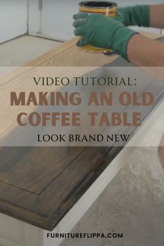 an old coffee table is being painted with white paint and some green gloves on it