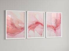 three abstract paintings hanging on the wall