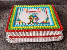 a birthday cake decorated with an image of a cartoon character on the front and sides