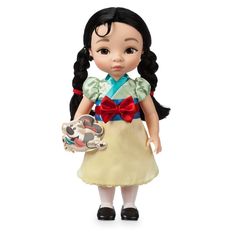 the doll is holding a koala bear and wearing a dress with red bows on her head