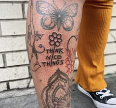 a person with tattoos on their legs and the words think nice things written in different languages