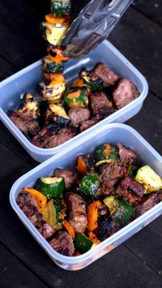 two plastic containers filled with meat and veggies