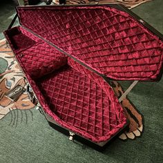 an open suit case sitting on top of a carpeted floor next to a rug