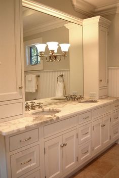 a large bathroom with two sinks and mirrors