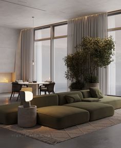 a living room with large windows and a green couch