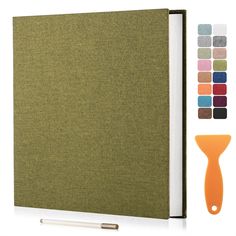 an open book with different colors on the cover and a pen next to it,