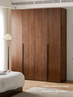 a bed sitting next to a wooden closet in a bedroom