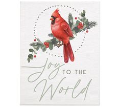 a red bird sitting on top of a white card that says joy to the world