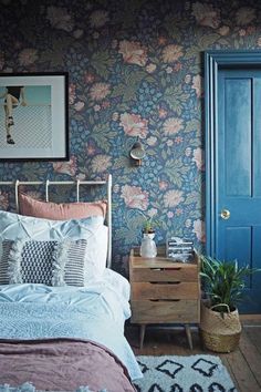 a bed room with a neatly made bed and a blue door