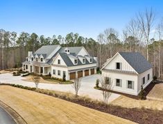 an aerial view of a large home in the middle of a wooded area with lots of trees