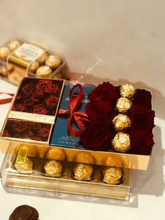 a box filled with chocolates and roses on top of a table