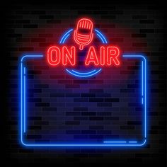 a neon sign that says on air with a microphone in the center and an oval frame