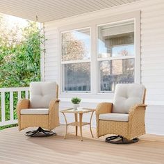 two chairs and a table on a porch