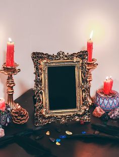 a table with candles, a mirror and other items on it