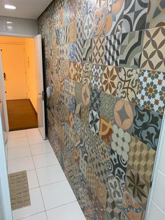 a hallway with tiled walls and tile flooring