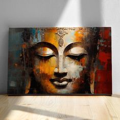 a painting of a buddha face on a wooden table