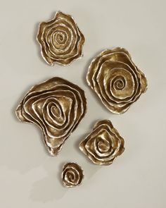 three pieces of metal that have been made to look like flowers