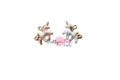 two unicorn shaped charms with gold and silver colored metal fittings on each earring