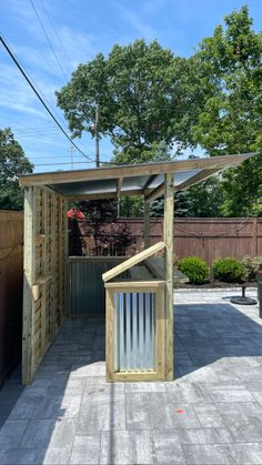 a small wooden structure sitting in the middle of a yard