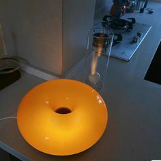 a yellow glass bowl sitting on top of a counter