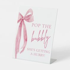 a greeting card with a pink bow on the front that says pop the bubbly she's getting a hubby