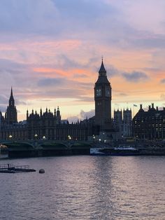 the big ben clock tower towering over the city of london, england at sunset or dawn