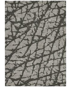 an area rug with grey and white designs on it, including the design of a tree trunk