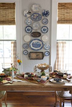 a dining room table with plates on the wall