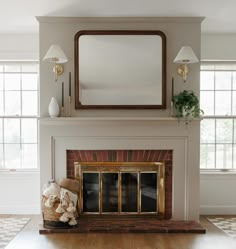 a living room with a fire place and mirror