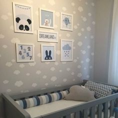 a baby crib in a room with pictures on the wall