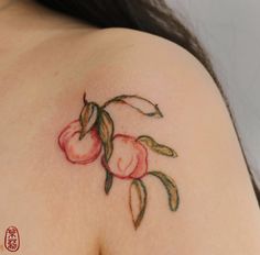 a close up of a tattoo on the back of a woman's shoulder and breast