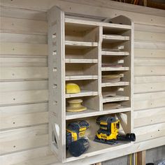 a workbench with two drillers and other tools on the shelf next to it