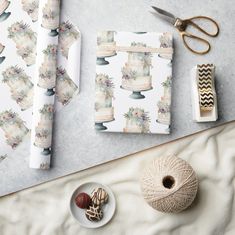 a table topped with lots of crafting supplies next to a pair of scissors and yarn