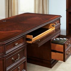 a wooden desk with drawers underneath it