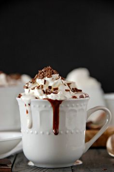 a white cup filled with hot chocolate and whipped cream