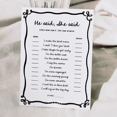 the wedding game is set up on top of a white tablecloth with black writing