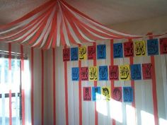 a room decorated with red, white and blue striped drapes for the curtained area