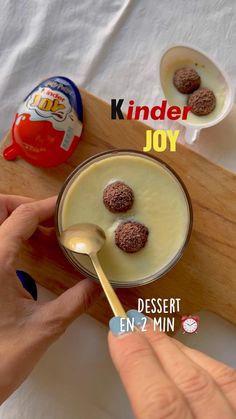 a person is spooning some kind of dessert into a small bowl on a cutting board